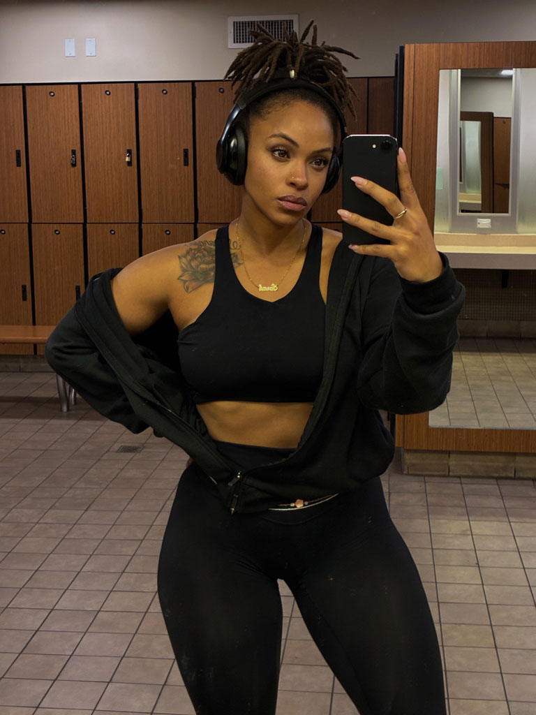Coach taking a mirror selfie in a gym locker room.